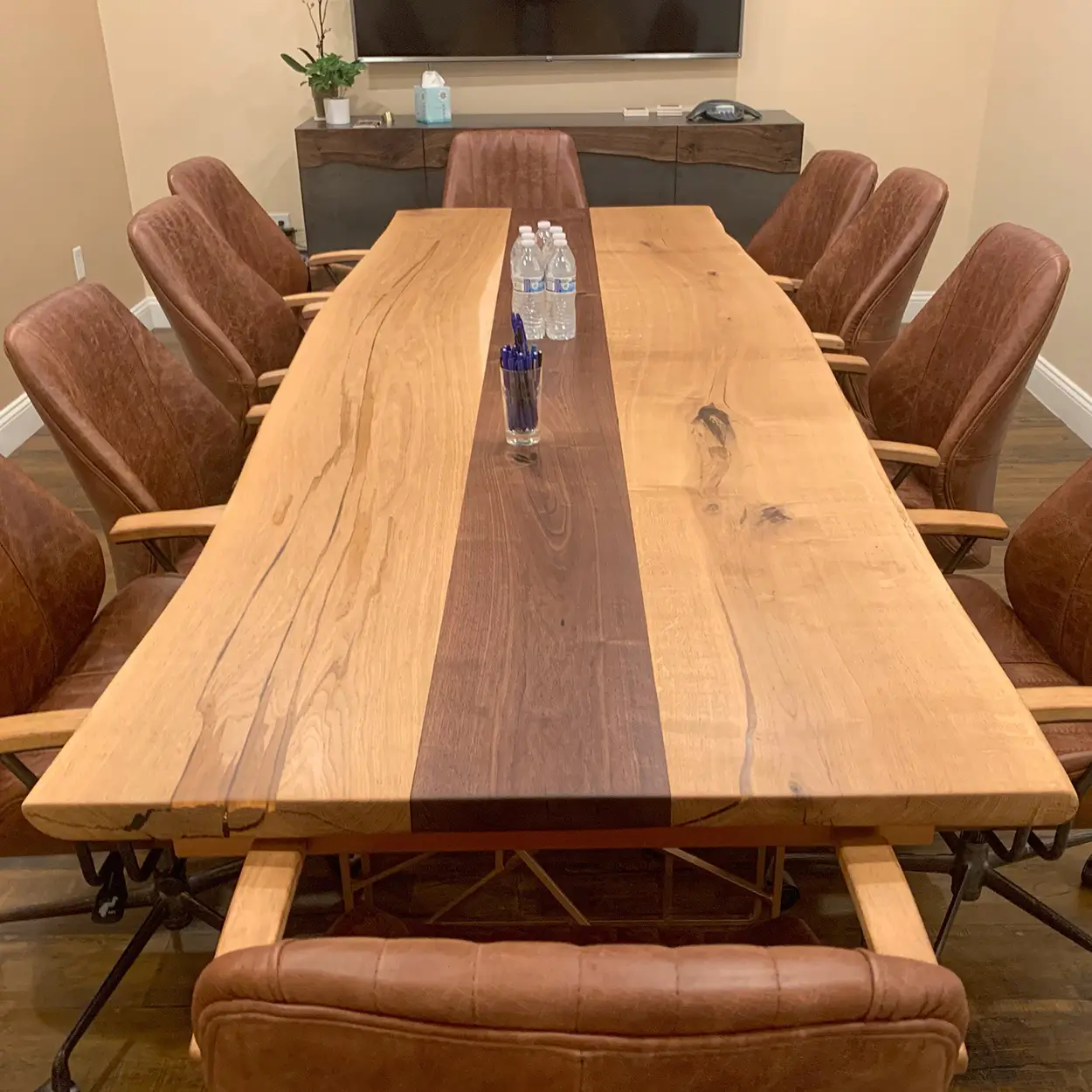 An empty conference table and chairs set up for a mediation session